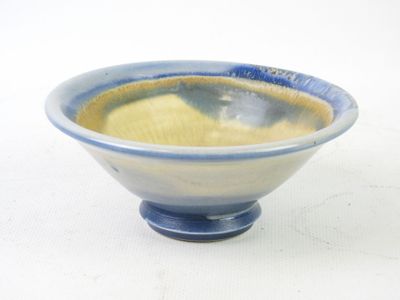 a blue and white bowl sitting on a white surface