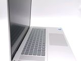 a silver laptop computer sitting on top of a white table