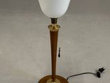 a close up of a lamp on a table with a cord
