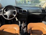 dashboard of a car with two brown leather seats and a steering wheel