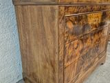 an image of a wooden chest of drawers sitting on a sidewalk