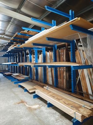 many shelves that are in a warehouse with wood and metal