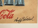 a picture of a coca cola advertisement on the wall