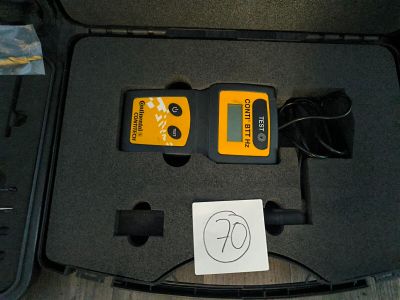 a box with two cables and a remote control in it
