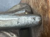 a close up of a piece of metal on a piece of wood