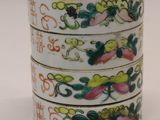 a stack of three cups sitting next to each other on a table