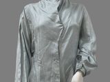 an image of a mannequin wearing a silver shirt and black pants