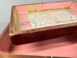 a pink suitcase with writing and a knife in it