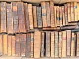 a box full of old books sitting on the floor