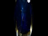 a blue glass vase with a white dot on it