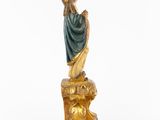 a statue of a woman sitting on top of a rock