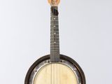 an old banjo is hanging from a string on a wall