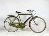 a green bicycle that is parked on a white surface