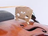 a close up of a violin with a bow on top of it