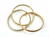 three gold wedding rings on a white background