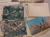 a pile of old postcards and old postcards on a table