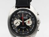 a close up of a wrist watch with a black dial