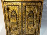 an old wooden cabinet with two doors and a door handle