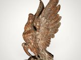 an image of a statue of a bird on a wooden base