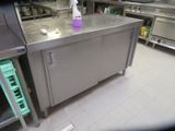 a stainless steel counter with a bottle of cleaner on top of it