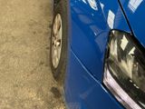 a blue car that is parked on the side of the road