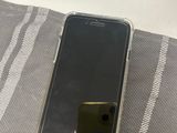 an iphone is sitting on top of a blanket on a bed