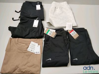 several pairs of men ' s nike sweatpants are on a table