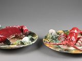 une paire d'assiettes en céramique représentant un crabe et une homard