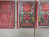 three books that are sitting on a tiled floor