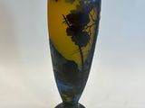 a vase with a painting on it sitting on a table
