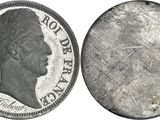 a close up of a silver coin with a woman ' s face on it