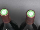 six bottles of wine are lined up in a row on a table