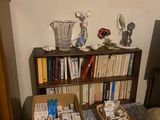 a bed with a book shelf and a chair in the corner