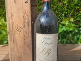 two bottles of wine sitting on a table next to a wooden box
