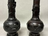 two vases that are sitting on a table
