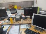 an image of a cluttered desk with two computer monitors and a keyboard
