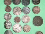 several different types of coins on a green surface