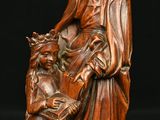 an image of a wooden statue of a woman holding a child