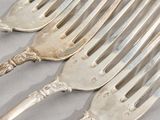 four forks that are sitting next to each other