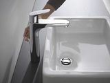 a person that is washing their hands in a bathroom sink