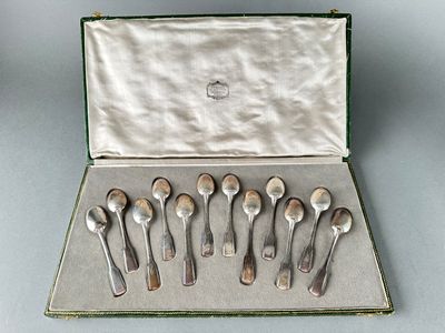 six spoons in a case on a table