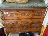 a chest of drawers with a basket on top of it
