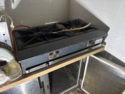 a gas stove in the corner of a kitchen