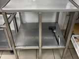 a stainless steel table with a bottle on top of it