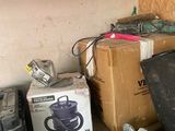 a pile of assorted items on a shelf in a room