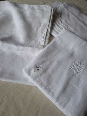 three towels that have been embroidered on them on a bed
