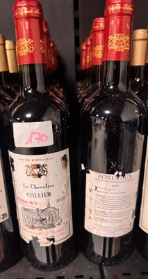 several bottles of wine are lined up on a shelf in a store