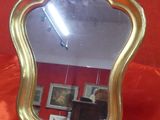 a mirror that is sitting on a red cloth