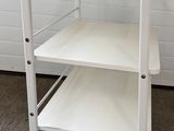 a white cart that has two shelves on top of it