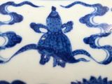 a blue and white plate with a fish design on it
